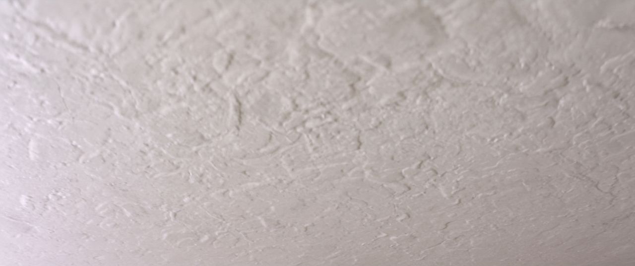 Close view of a modern knockdown ceiling texture in soft light