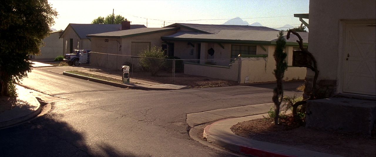 Street of single-story mid-century ranch homes in Albuquerque with xeriscaped yards